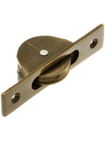 Traditional Cast Brass Sash Pulley With 1 3/4 inch Wheel in Antique Brass finish.